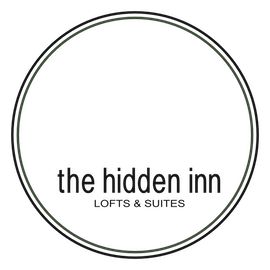 Circular logo gray ring around a dark center with unreadable inner text